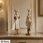 Royal Rabbit Couple Figurines – set of 2 tall resin sculptures in white and gold baroque attire on marble console