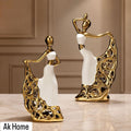 Gold & White Dancing Lady Ceramic Figurines – set of 2 on marble surface with gold filigree skirts