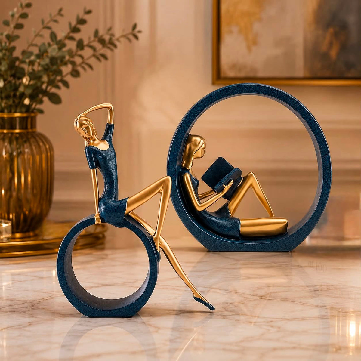 Leisure Lady Ring Sculpture Set of 2 – navy blue and gold resin stretching and reading lady figurines on marble floor