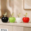 Glossy Ceramic Apple Figurine with Gold Leaf Stem — product photograph at AK Home