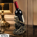 Skeleton Wine Bottle Holder – antique gold resin gothic sculpture cradling a wine bottle