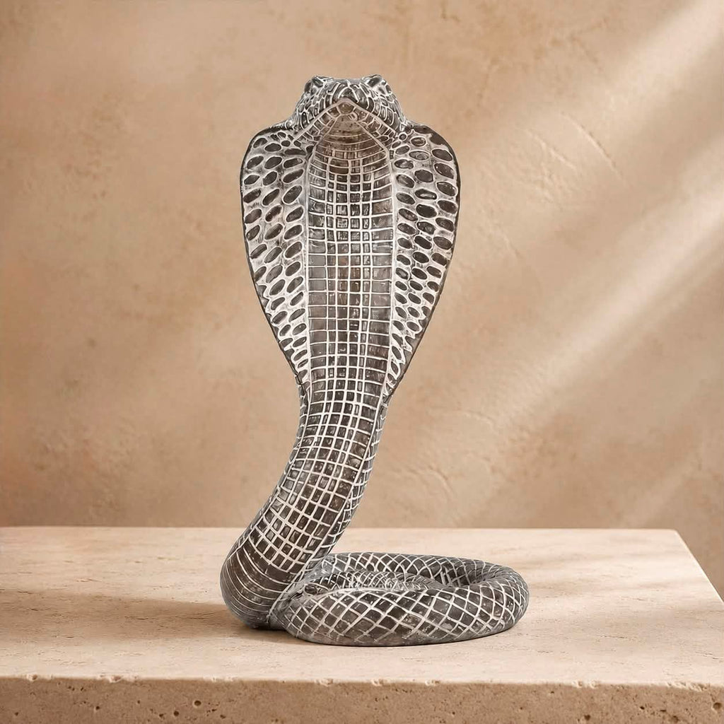 Cobra King Resin Sculpture – antique silver hooded cobra figurine on travertine surface
