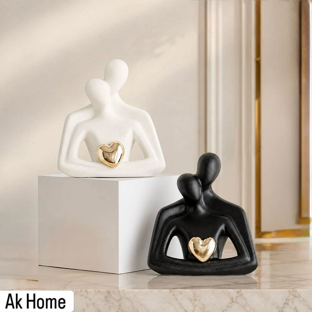 Abstract Figure Ceramic Sculpture with Gold Heart – matte white and black minimalist figurines on marble surface