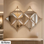 Luxury 3-piece gold geometric diamond mirror set with curved metal framework and beveled mirror glass panels on wall