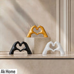 Heart Hands Resin Sculpture – set of three in matte black, matte white, and gold on marble shelf
