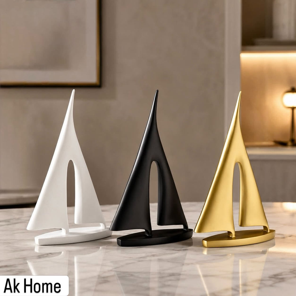 Minimalist Sailboat Sculpture – set of three in matte white, matte black, and brushed gold on marble surface