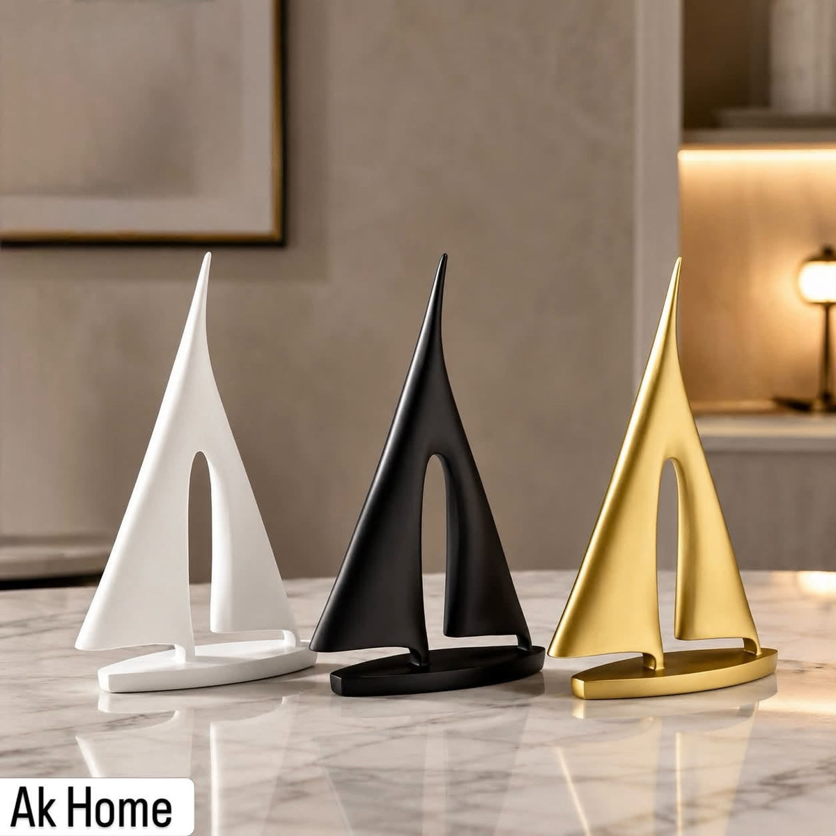 Minimalist Sailboat Sculpture – set of three in matte white, matte black, and brushed gold on marble surface